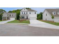 Charming two-story home with manicured lawn, porch, and an attached two car garage at 540 Teversham Dr, Mcdonough, GA 30253