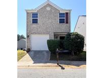 Charming two-story home with a brick facade, attached garage, and well-maintained landscaping at 2089 Belmont Cir, Conyers, GA 30012