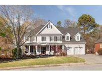 Traditional two-story home with a manicured front lawn and a three-car garage, perfect for a Gathering at 6236 Benbrooke Nw Dr, Acworth, GA 30101