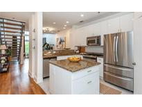 Modern kitchen with stainless steel appliances, granite countertops, and white cabinetry at 1253 Caroline Ne St # 229, Atlanta, GA 30307