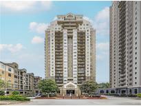 Modern high-rise condo building featuring private balconies and beautiful landscaping at 795 Hammond Dr # 806, Sandy Springs, GA 30328