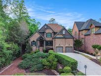 Charming brick home featuring mature landscaping, symmetrical design, and a two-car garage at 3574 N Druid Hills Rd, Decatur, GA 30033