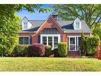 Charming brick home with a well-manicured lawn and mature landscaping at 479 Shannon Sw Dr, Atlanta, GA 30310