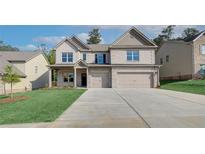 Beautiful two-story home featuring a brick facade and a three-car garage at 119 Felicity Pike, Locust Grove, GA 30248