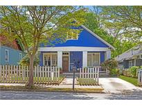 Charming blue two-story home with a inviting front porch and picket fence, perfect for relaxing outdoors at 836 Dill Sw Ave, Atlanta, GA 30310