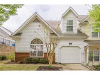 Charming home featuring a one-car garage, lovely landscaping, and large arched window offering natural light at 1052 Pike Forest Ct, Lawrenceville, GA 30045