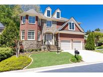 Beautiful two-story home with stone accents, manicured lawn, and a two-car garage at 3759 Wescott Ne Cv, Brookhaven, GA 30319