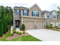 Charming two-story home featuring a stone facade and a two-car garage, enhancing curb appeal at 5638 Berney Cir, Powder Springs, GA 30127
