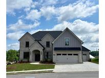 New two-story home featuring a two-car garage and manicured lawn at 4201 Hosch Reserve Dr, Buford, GA 30519
