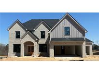 Beautiful new construction home with a light brick exterior and a two-car garage at 4201 Hosch Reserve Drive Park, Buford, GA 30519