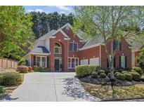 Charming two-story brick home with a well-manicured lawn and an extended driveway at 4232 Millside Se Walk, Smyrna, GA 30080