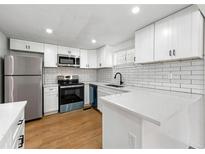 Modern kitchen with white cabinets, stainless steel appliances, and subway tile backsplash at 1917 Connally Dr, Atlanta, GA 30344