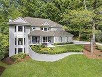 Beautiful two-story home featuring manicured lawn and lush landscaping at 660 Willow Knoll Se Dr, Marietta, GA 30067