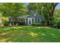 Charming single-story home with a lush green lawn and mature trees in a quiet neighborhood setting at 1248 Conway Rd, Decatur, GA 30030
