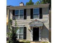 Two story home with cream colored siding and black shutters at 3082 Revere Ct, Atlanta, GA 30340