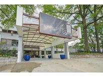 Renaissance Lofts building entrance featuring a modern canopy and well-maintained landscaping at 120 Ralph Mcgill Ne Blvd # 1304 & 1305, Atlanta, GA 30308