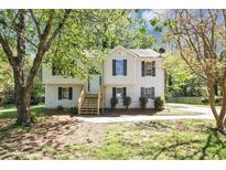 Charming two-story home with a well-maintained front yard and classic curb appeal in a serene neighborhood at 1327 Laura Ln, Austell, GA 30168