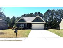 Charming single-story home with a well-manicured front yard and attached two-car garage at 142 Susie Creek Ln, Villa Rica, GA 30180