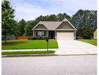 Charming single-story home with a well-maintained lawn, attached garage, and tasteful landscaping at 142 Susie Creek Ln, Villa Rica, GA 30180
