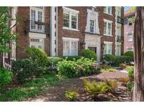 Beautifully landscaped front yard with lush greenery and colorful flower beds at 20 Collier Nw Rd # 11, Atlanta, GA 30309