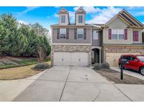 Charming townhome with a two-car garage and well-maintained front yard in a Gathering-friendly neighborhood at 2722 Sardis Chase Ct, Buford, GA 30519