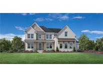 Charming two-story home featuring a mix of brick and stone accents, a dark roof and a beautifully landscaped front yard at 4995 Travers Ln, Cumming, GA 30040