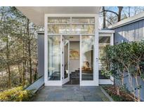Stylish home entrance featuring glass doors, stone floors, and a modern design at 1105 Crest Valley Dr, Sandy Springs, GA 30327