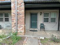 Cozy front porch featuring neutral siding and a green front door and two windows at 3071 Colonial Way # K, Atlanta, GA 30341