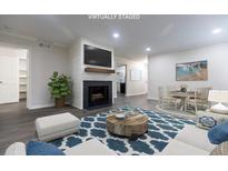 Cozy living room features a modern fireplace, wood floors, and open floor plan at 600 Bedfort Dr, Duluth, GA 30096
