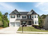 Beautiful two-story home with a brick and siding exterior, two-car garage, and manicured lawn at 4685 Columbia St, Cumming, GA 30040