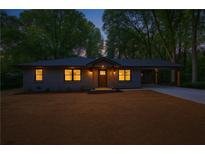 Charming single-story home with a covered carport and inviting front entrance at dusk at 1995 Mcafee Rd, Decatur, GA 30032
