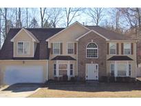 Charming two-story home featuring a brick facade, attached garage, and well-maintained lawn at 193 Edison Dr, Stockbridge, GA 30281
