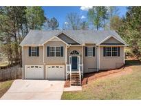 Charming two-story home with a well-manicured lawn, inviting entrance, and a two-car garage at 33 Blue Springs Way, Dallas, GA 30157