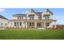Beautiful two-story home with a brick facade, a covered porch, and a well-manicured lawn at 5130 Travers Ln, Cumming, GA 30040