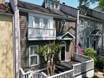 Charming two-story townhome features a welcoming front porch and classic architectural details at 957 Piedmont Ne Ave # A, Atlanta, GA 30309