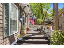 Inviting front porch with wood flooring, patriotic decor, seating, and natural light for relaxing outdoors at 957 Piedmont Ne Ave # A, Atlanta, GA 30309