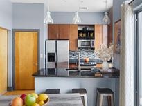 Stylish kitchen with stainless steel appliances, dark countertops, breakfast bar, and pendant lighting at 2630 Talley St # 319, Decatur, GA 30030
