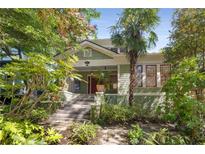 Charming two-story home with green siding, landscaped yard, and inviting front porch at 374 8Th Ne St, Atlanta, GA 30309