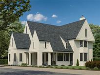 Striking exterior view of a two-story home with dark gray roof and cream-colored siding, showcasing its modern design at 100 Carlyle Ln, Fayetteville, GA 30214