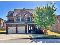 Beautiful two-story brick home with a well-manicured lawn and a two-car garage at 2269 Reddy Farm Ln, Grayson, GA 30017
