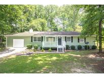 Charming single-story home with a manicured front yard and inviting front porch at 879 Rock Oak Ln, Lawrenceville, GA 30046