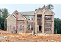 New home with classic brick facade and multi-pane windows under construction at 247 Lotus Ln, Covington, GA 30016