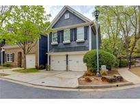 Charming two-story home with a two-car garage and beautifully landscaped front yard with blue siding and black shutters at 2700 Ridge Run Tr Trl, Duluth, GA 30097