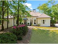 Stunning single-story home with manicured lawn, lush landscaping, and inviting entrance at 300 Brayward Chase, Roswell, GA 30076