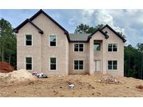 New two-story brick home featuring a symmetrical design with dark roof and window trim at 237 Lotus Ln, Covington, GA 30016