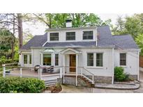 Charming white brick home with a cozy front deck and well-manicured landscaping, perfect for outdoor relaxation at 2840 Alpine Rd, Atlanta, GA 30305
