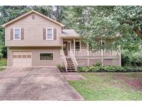 Charming two-story home with a well-maintained lawn and a cozy front porch at 7060 Steel Wood Nw Dr, Kennesaw, GA 30152