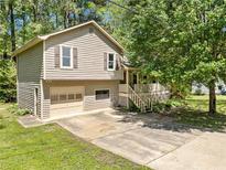 Charming two-story home with a well-maintained lawn and attached one car garage at 7060 Steel Wood Nw Dr, Kennesaw, GA 30152