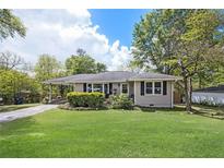 Charming single-story home with a well-maintained front yard and beautiful landscaping at 4061 Newman Ellis Rd, Douglasville, GA 30134