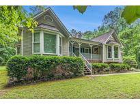 Charming home featuring well-manicured landscaping and a cozy covered front porch at 469 Kimberly Ct, Mcdonough, GA 30252